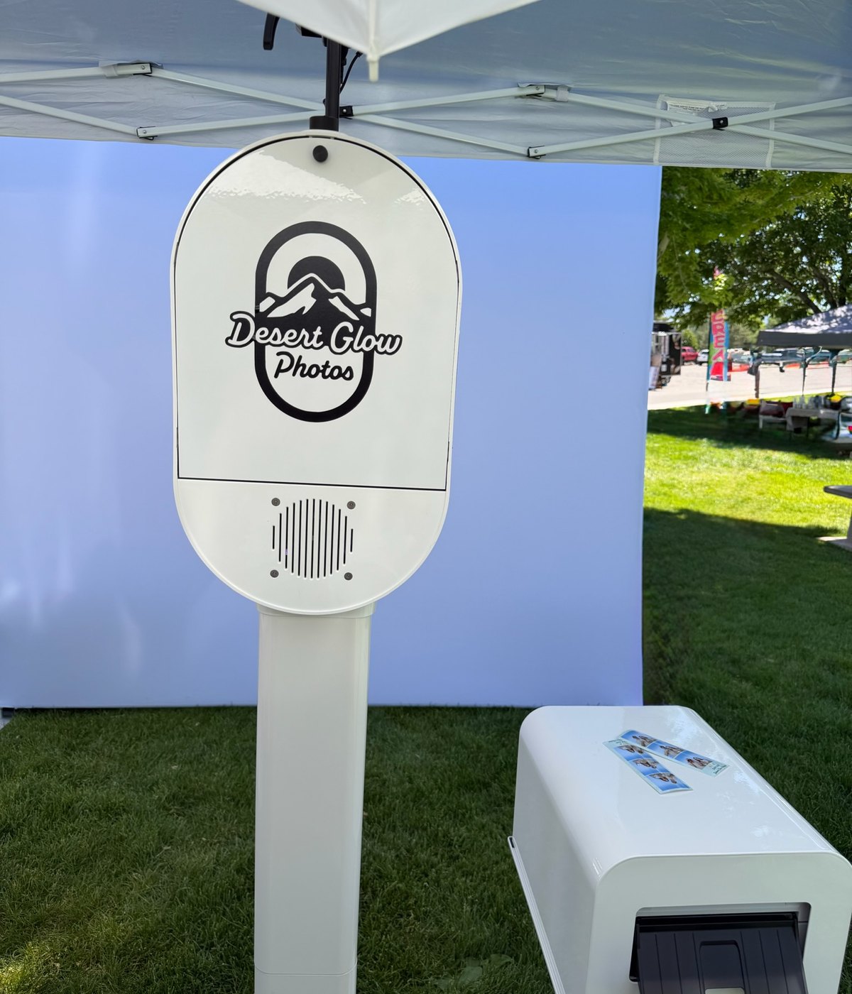 The Desert Glow Photos booth set up outdoors on the grass