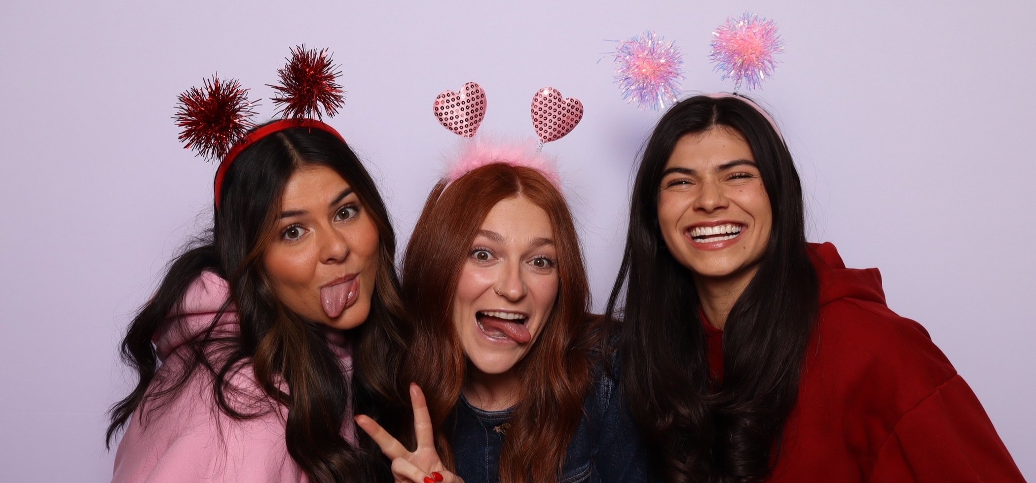 Three guests posing together in the booth