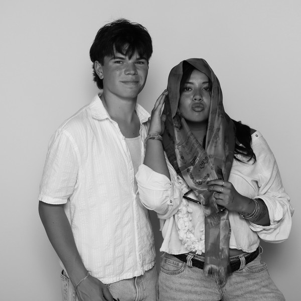 Black-and-white portrait of a man in a white shirt and a woman with a scarf over her head