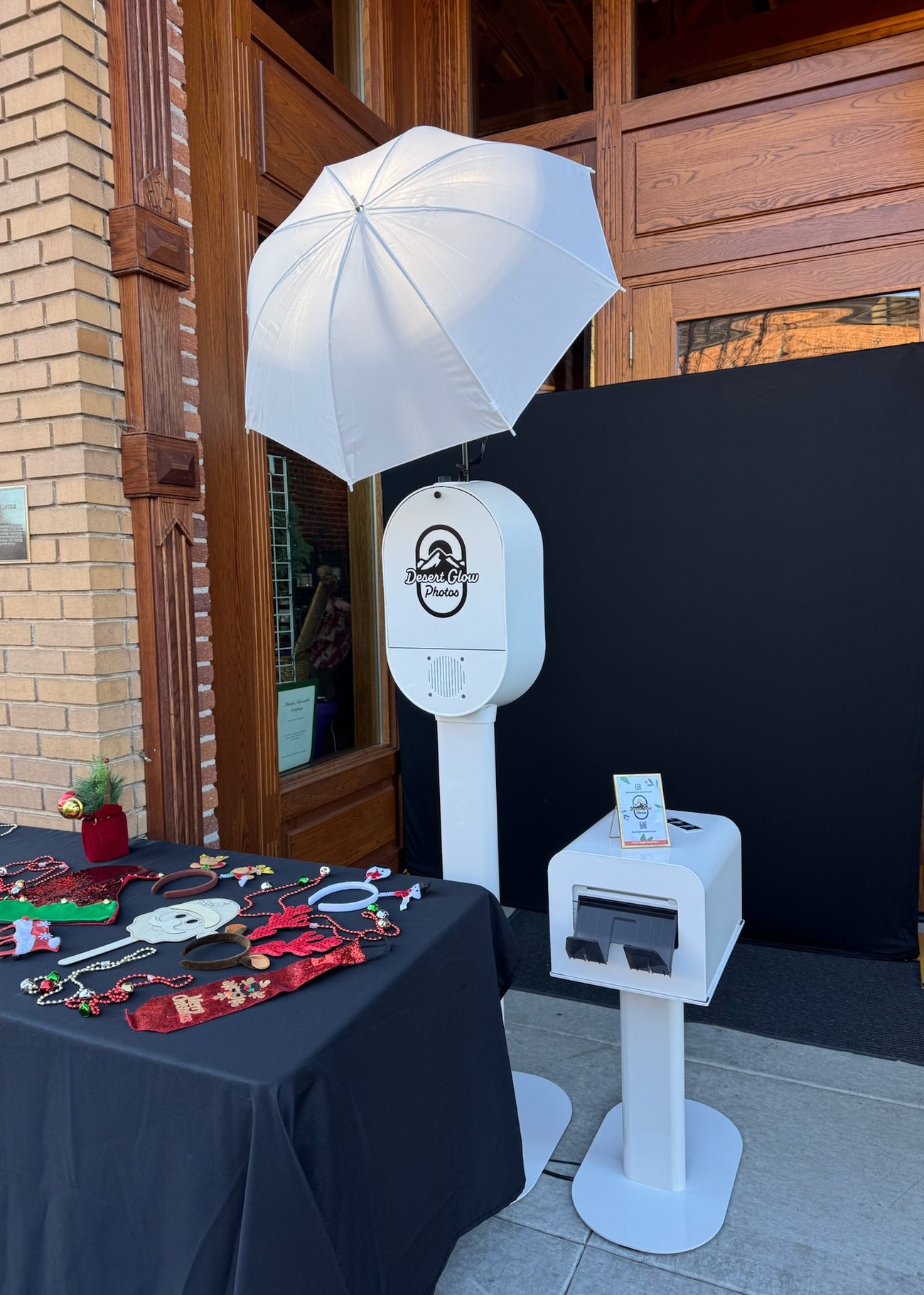 The Desert Glow Photos booth set up beside a table of props