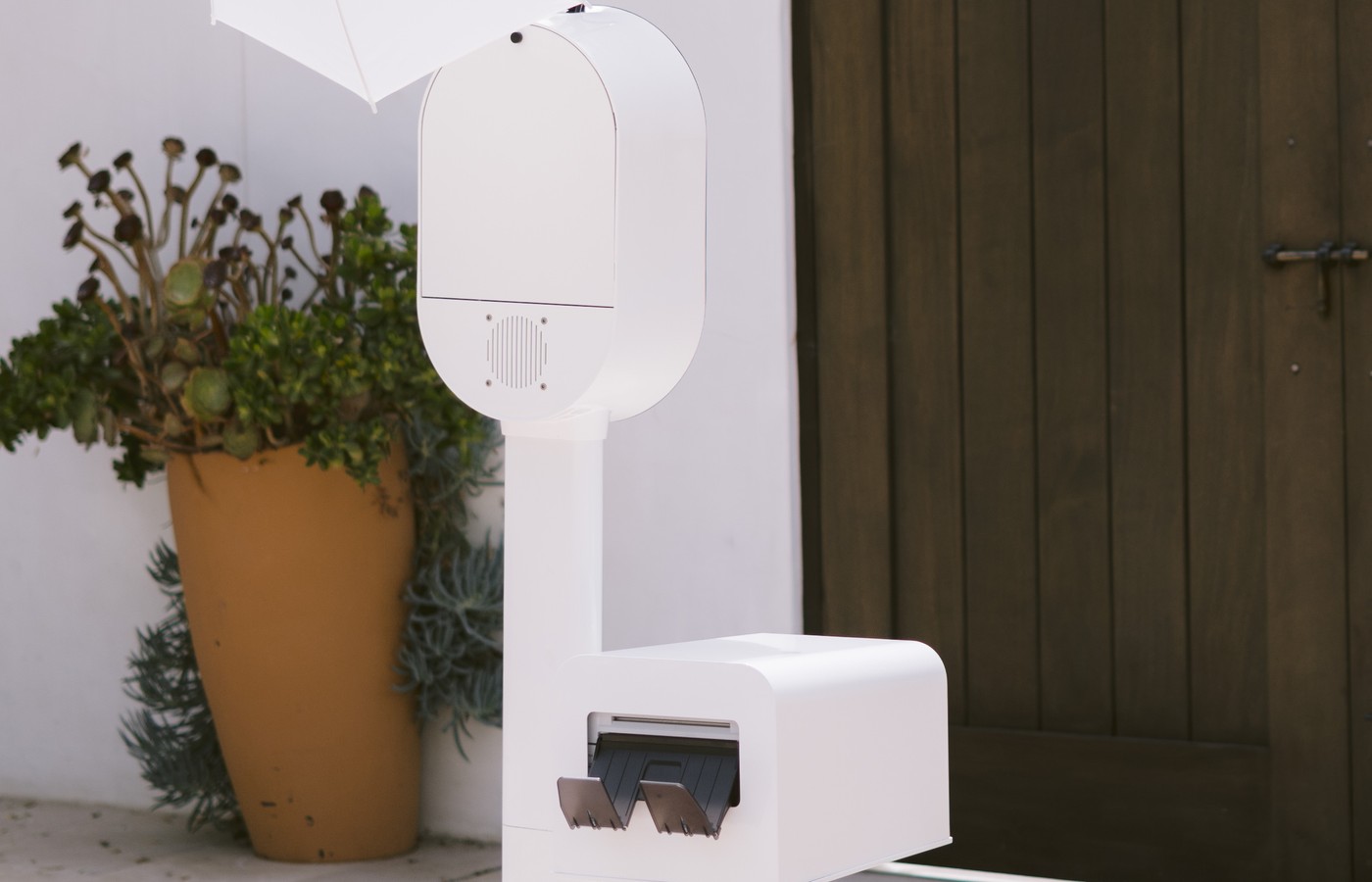 The Desert Glow Photos booth set up outdoors beside a planter