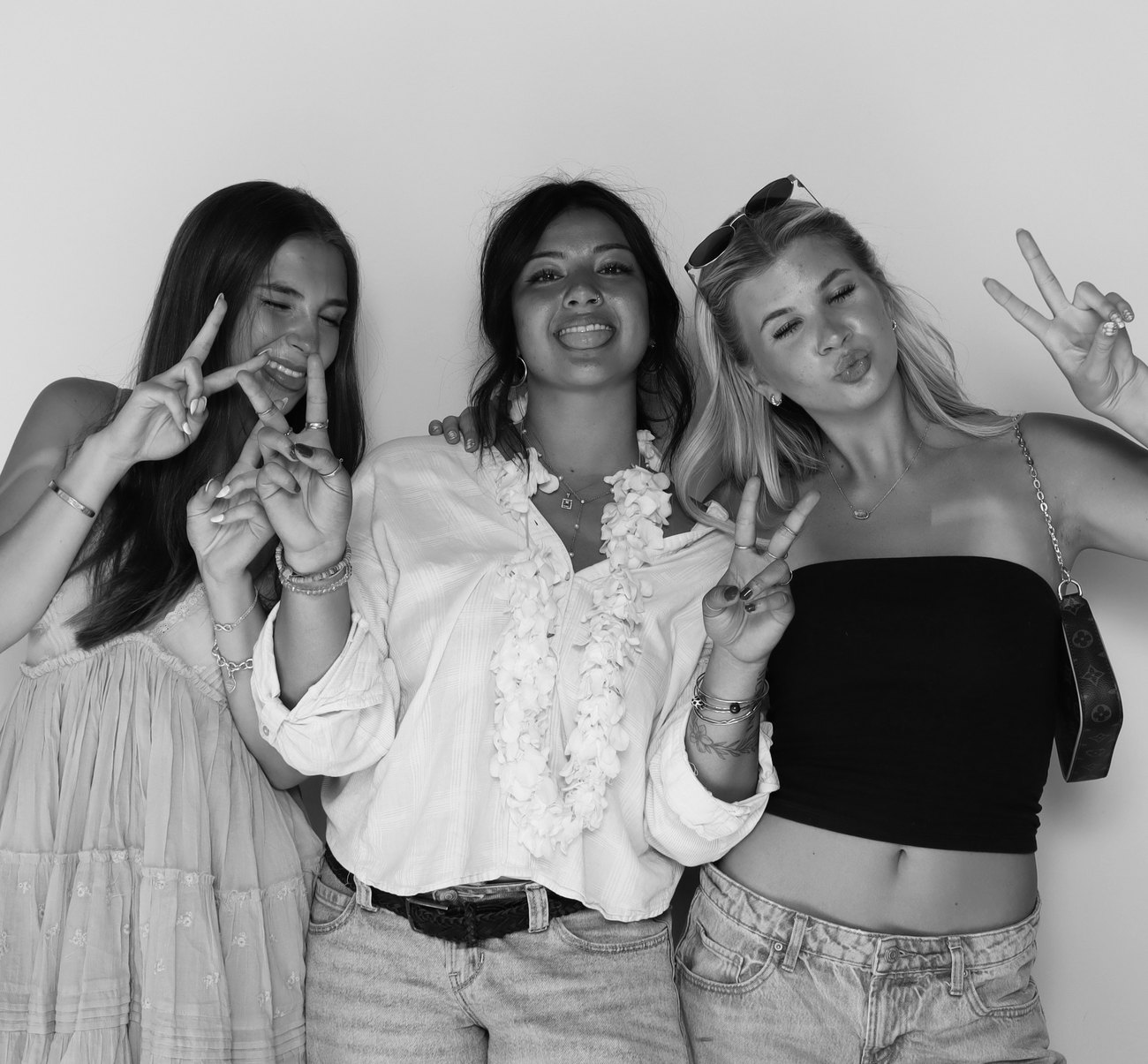 Three guests posing together in the booth